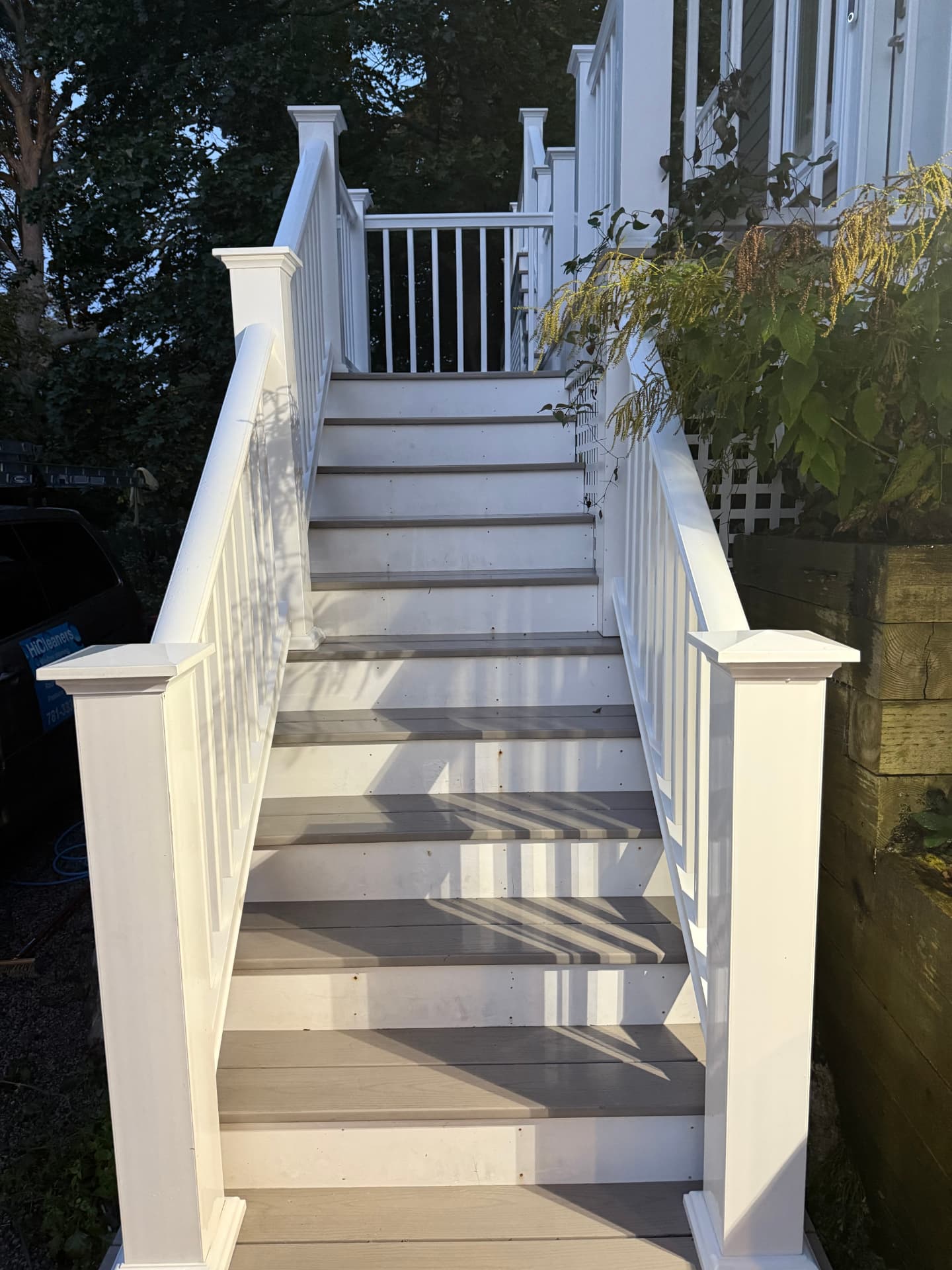 The same white deck steps and railings bright and clean after washing