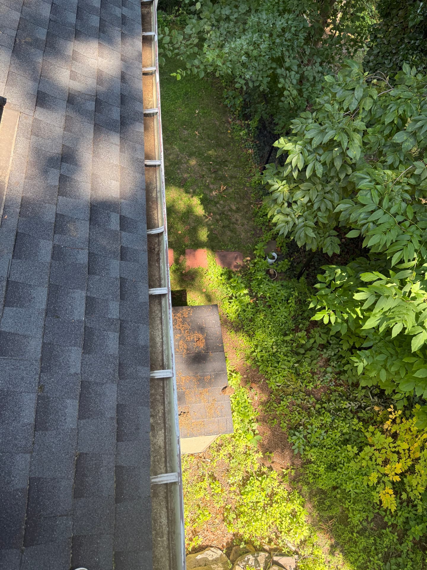 Same gutter section clear of debris after cleaning